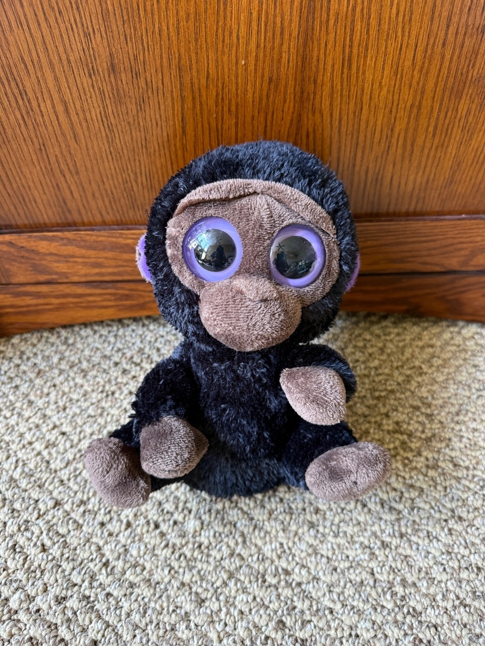 black monkey plush stuff animal with purple eyes